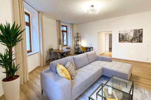 a living room with a couch and a table at Business - YR Apartment - Citynah, WLAN, Drucker in Chemnitz