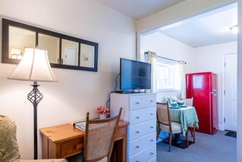 a living room with a desk and a red refrigerator at Log Cabin Motel in Pinedale