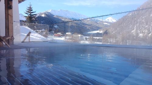 a swimming pool with a view of a mountain at Hotel Crusch Alba Sta Maria in Santa Maria Val Müstair