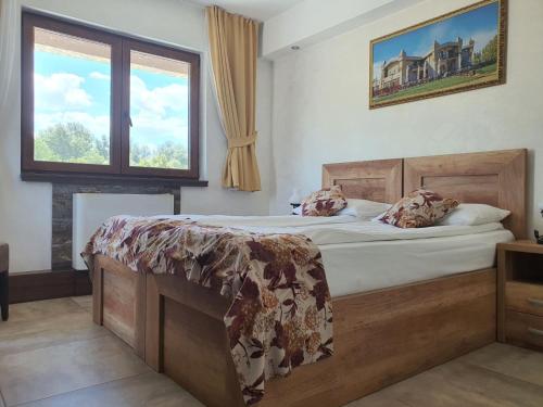 a bedroom with a bed and a window at Bački dvor in Vajska