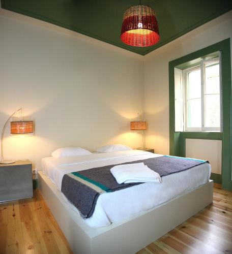 a bedroom with a large white bed in a room at 29 Madeira Hostel in Funchal