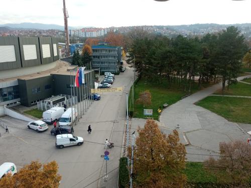 a street with cars parked in a parking lot at M Central Park in Niš