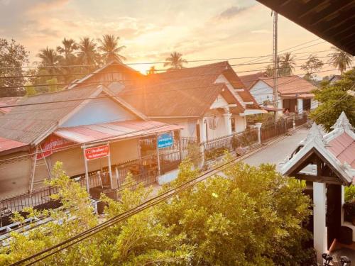 a train station with buildings and a train track at Moonlight Champa Riverview in Luang Prabang
