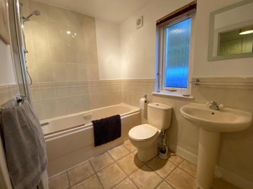 a bathroom with a toilet and a sink and a tub at Grampian Serviced Apartments - Garden Neuk - Lesmurdie House in Elgin