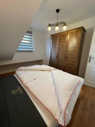 a large bed in a bedroom with a window at Apartman MN Teslic in Teslić