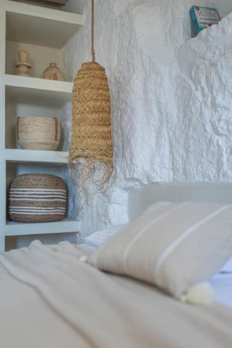 a bedroom with a bed with a pillow and a shelf at fragoseco dream accommodation! in Emporeiós
