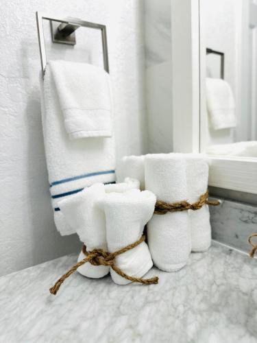 a bathroom with a pile of towels and a mirror at Home in Miami in Miami