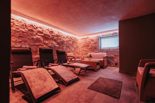 a stone room with chairs and tables and a window at Gazdov dvor in Dolný Kubín