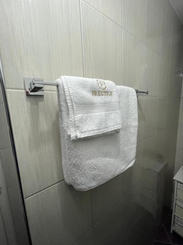 a white towel hanging on a towel rack in a bathroom at Apartman MN Teslic in Teslić