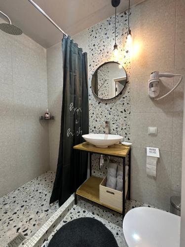 a bathroom with a sink and a mirror at Апартаменты Well - Being in Umanʼ