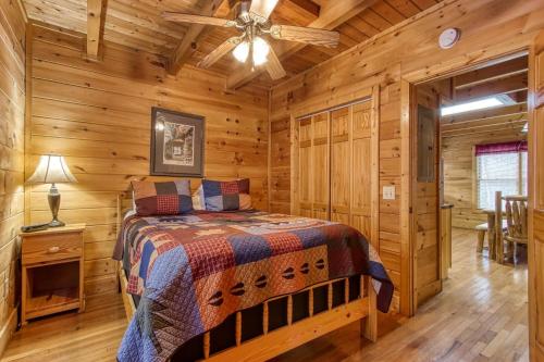 a bedroom with a bed in a log cabin at Point Of View - Spacious 2 Bedroom With a Loft Just off Glades Road cabin in Gatlinburg
