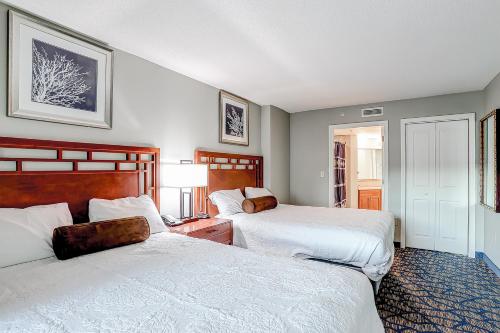a hotel room with two beds and a lamp at Ocean Blvd Resort, Unit #1234 in Myrtle Beach