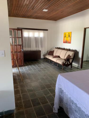 a room with two beds and a table in it at Casa do Vale in Triunfo