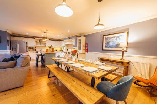 a living room with a long wooden table and a couch at The Vestry - Sleeps 12 - With Hot Tub in Haworth