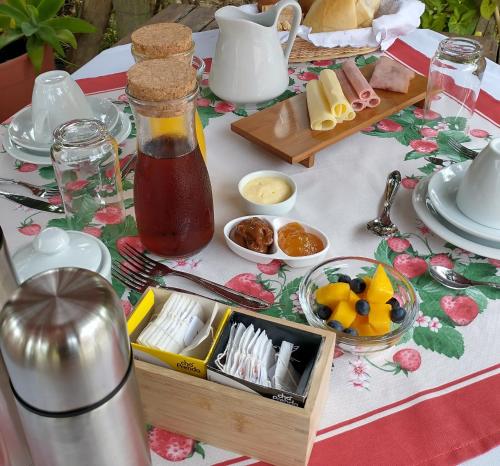 a table with a bottle of honey and a tray of food at Areias do Sol Suítes in Florianópolis