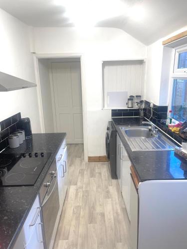 a kitchen with a sink and a counter top at Relaxing Crewe home in Crewe