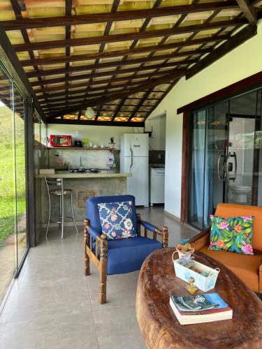 a living room with a couch and a table at Casa Cambuí Hospedagem Rural in Rio Prêto