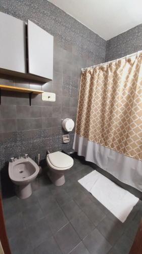 a bathroom with a toilet and a sink at HABITACIONES en casa palermo con terraza y parrilla in Buenos Aires