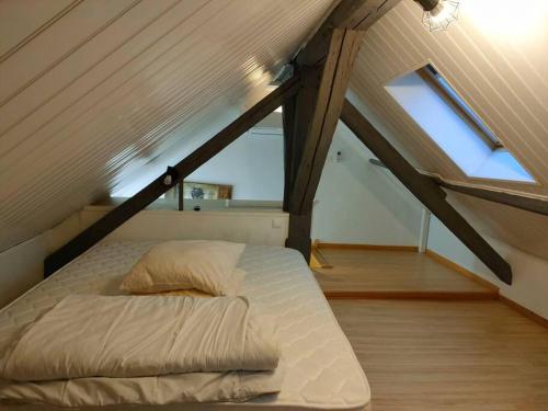 a bedroom with a bed in a attic at A la porte des vosges in Raon-lʼÉtape