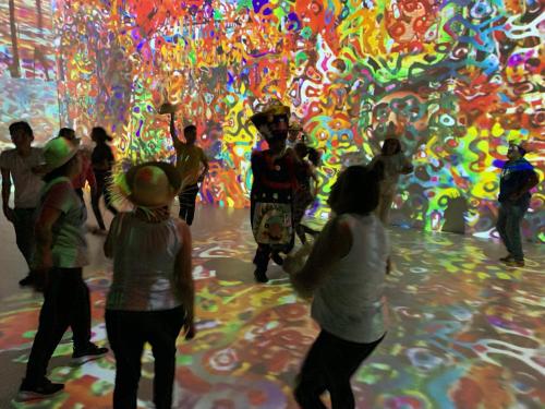 a group of people standing in front of a colorful wall at Hotel La Casa de los Árboles Immersive Experience in Zacualpan de Amilpas
