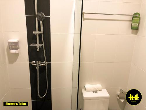 a shower stall in a bathroom with a toilet at VACA Apartments at Imperial Suites in Kuching