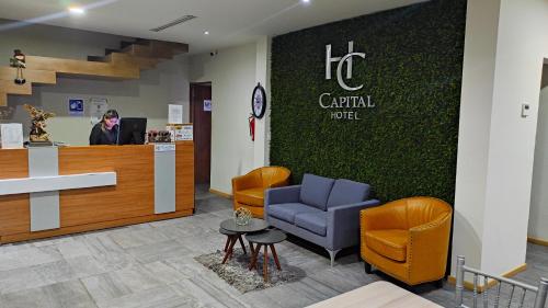a hospital lobby with a reception desk and chairs at Capital Hotel in Monclova