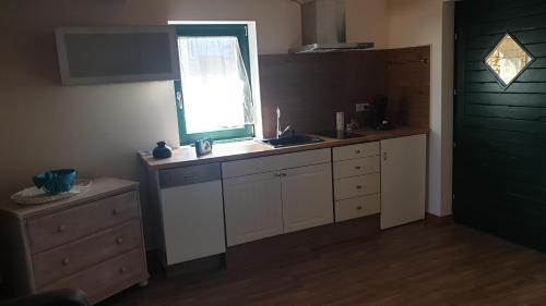 a kitchen with a sink and a window at Villa Maslina Šarić in Ðevrske