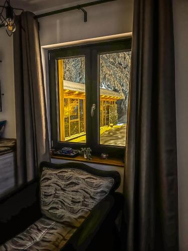 a window in a room with a bench in front of it at Vila Bašić Vlašić Apartman MEDO in Vlasic