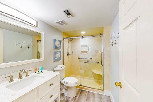 a bathroom with a shower and a toilet and a sink at Chateau La Mer 2A in Destin