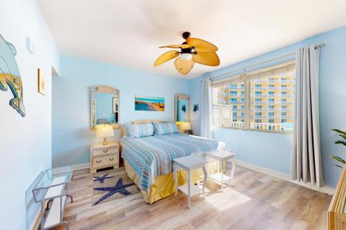 a bedroom with a bed and a ceiling fan at Shores of Panama, Unit #1415 in Panama City Beach