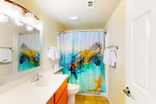 a bathroom with a shower curtain with a fish at Shores of Panama, Unit #1415 in Panama City Beach