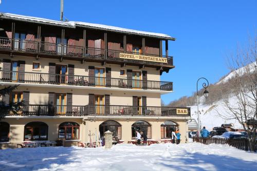 a large building with people standing outside in the snow at Le Relais du Galibier in Valloire