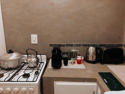 a kitchen counter with a stove and some pots and pans at Departamento próximo a la costanera y al aeropuert in Posadas