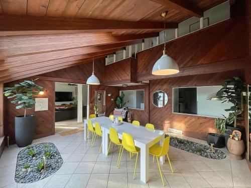 a dining room with a table and yellow chairs at Fun 4 BR Rexburg Retreat and Game Room, Sleeps 12 in Rexburg