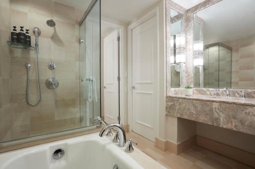 a bathroom with a tub and a shower and a sink at Beverly Wilshire, A Four Seasons Hotel in Los Angeles