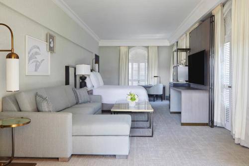 a living room with a couch and a bed at Beverly Wilshire, A Four Seasons Hotel in Los Angeles