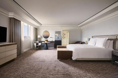 a hotel room with a large bed and a television at Beverly Wilshire, A Four Seasons Hotel in Los Angeles