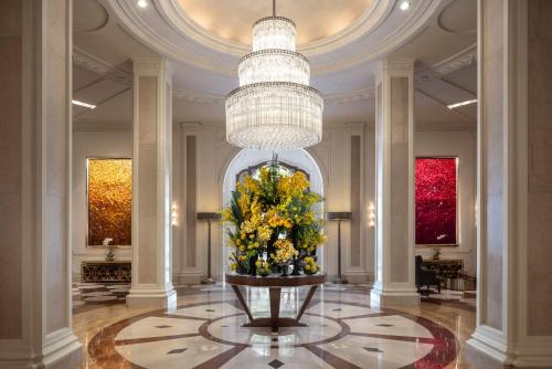 a lobby with a large vase with flowers in it at Beverly Wilshire, A Four Seasons Hotel in Los Angeles