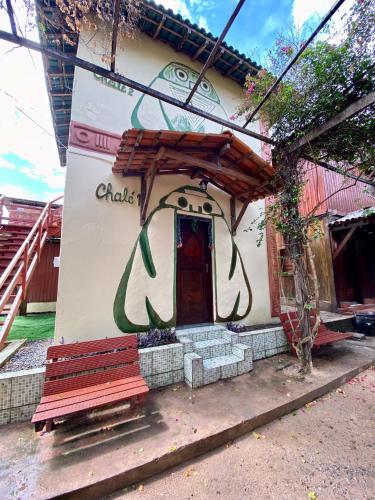 a building with a bench in front of it at Pousada Encantos da Amazônia in Alter do Chao