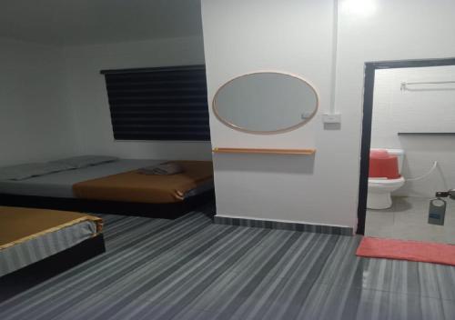 a small room with a bed and a mirror at Perhentian Bay Chalet in Perhentian Island