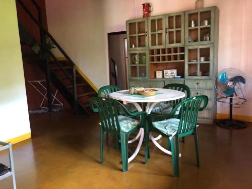 a table and chairs in a room with a staircase at Casa Ama in Puerto Iguazú