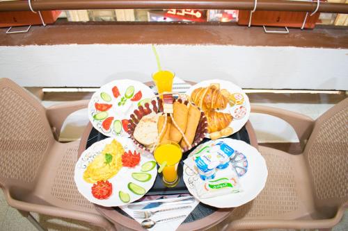 a table with plates of food on a table at Golden Palace Suites in Cairo