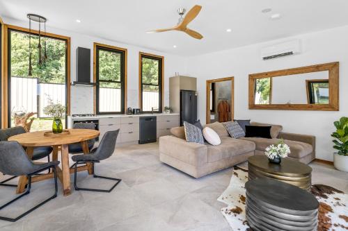 a living room with a couch and a table at Gan Eden Retreat-Byron bay , luxuries escape in Mullumbimby