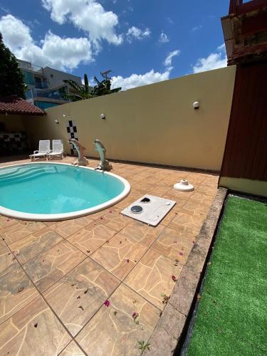 a swimming pool in the backyard of a house at Pousada Encantos da Amazônia in Alter do Chao