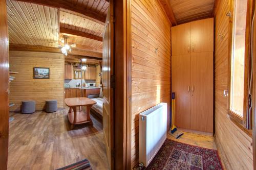 a room with wooden walls and a room with a table at Dolyna Gir in Bukovel