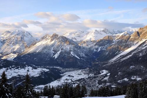 a view of a snowy mountain range with snow covered mountains at Albergo Stelvio in Bormio