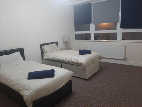 a room with two beds and a window at Spacious. Contractors. Brierley in Brierley Hill