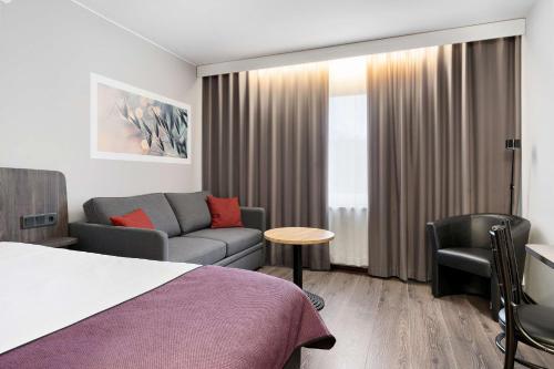 a hotel room with a bed and a couch at Best Western Karlshamn Spa & Relax in Karlshamn