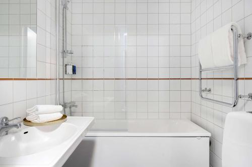 a white bathroom with a tub and a sink at Best Western Karlshamn Spa & Relax in Karlshamn