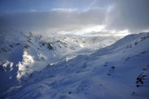 a mountain covered in snow with the sky in the background at Albergo Stelvio in Bormio